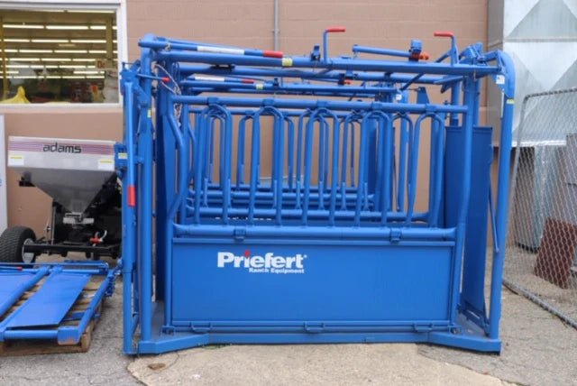 Blue livestock chute labeled 